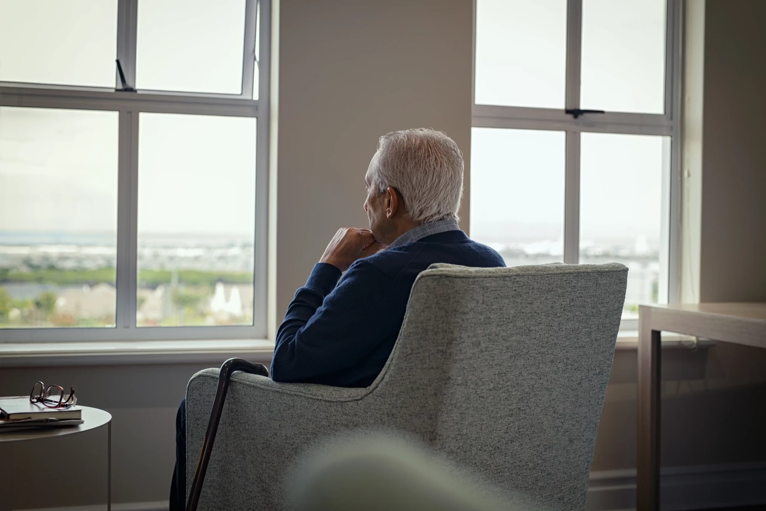 man sitting in the window of a nursing home