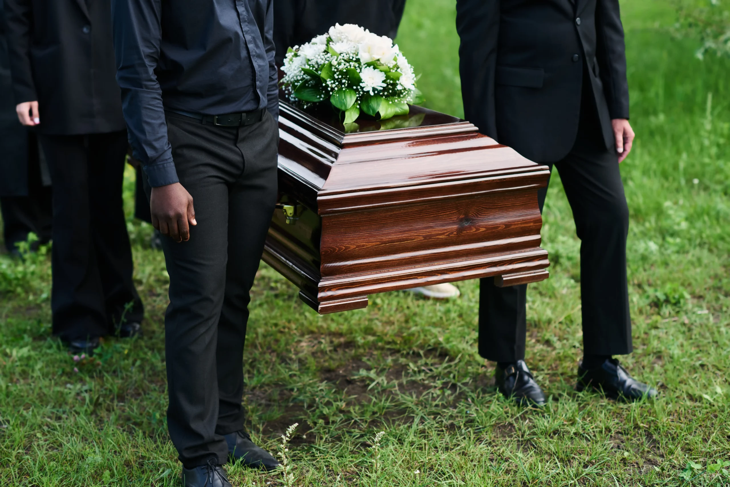 men holding a coffin after wrongful death