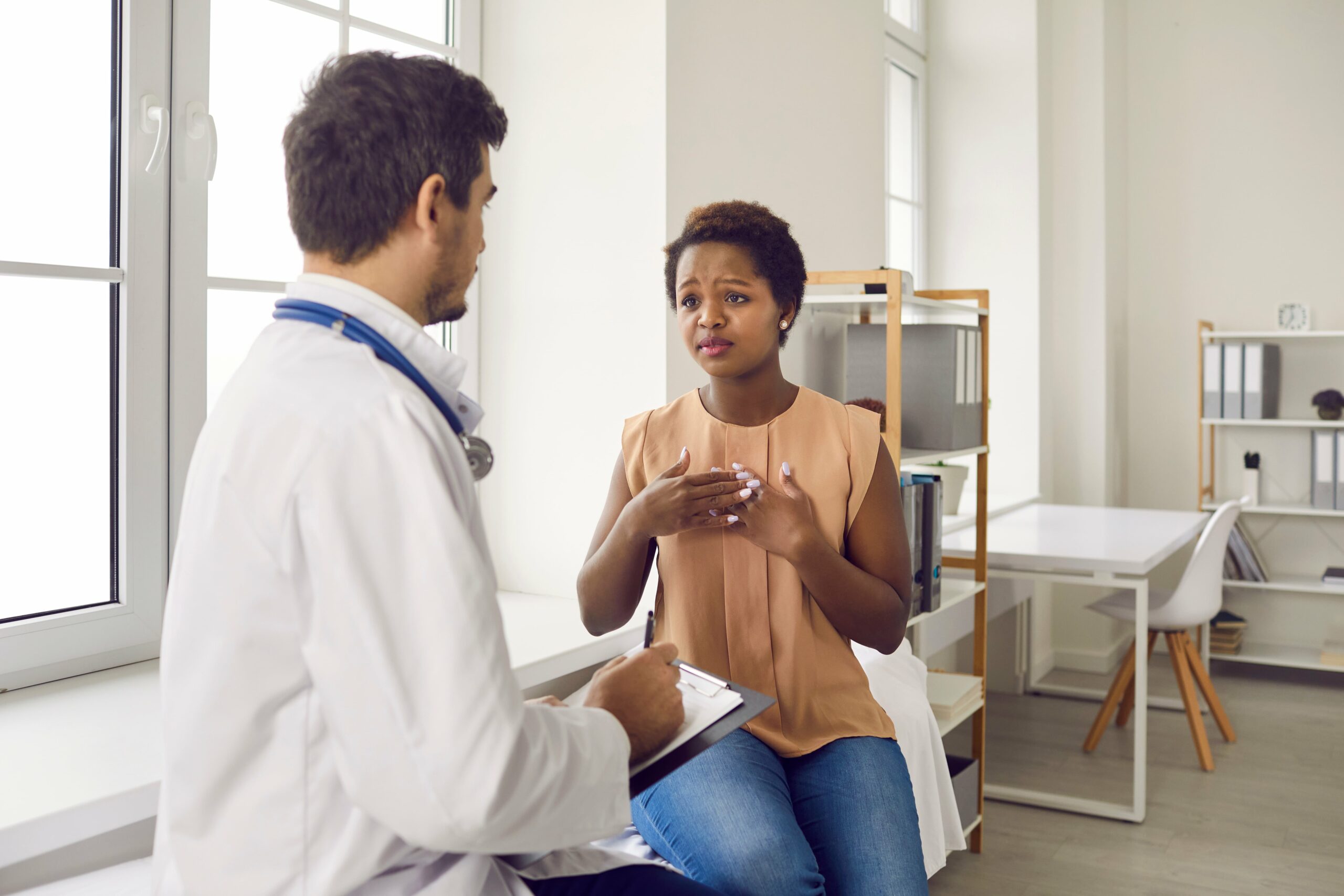 Woman hearing from the doctor she has signs of uterine cancer