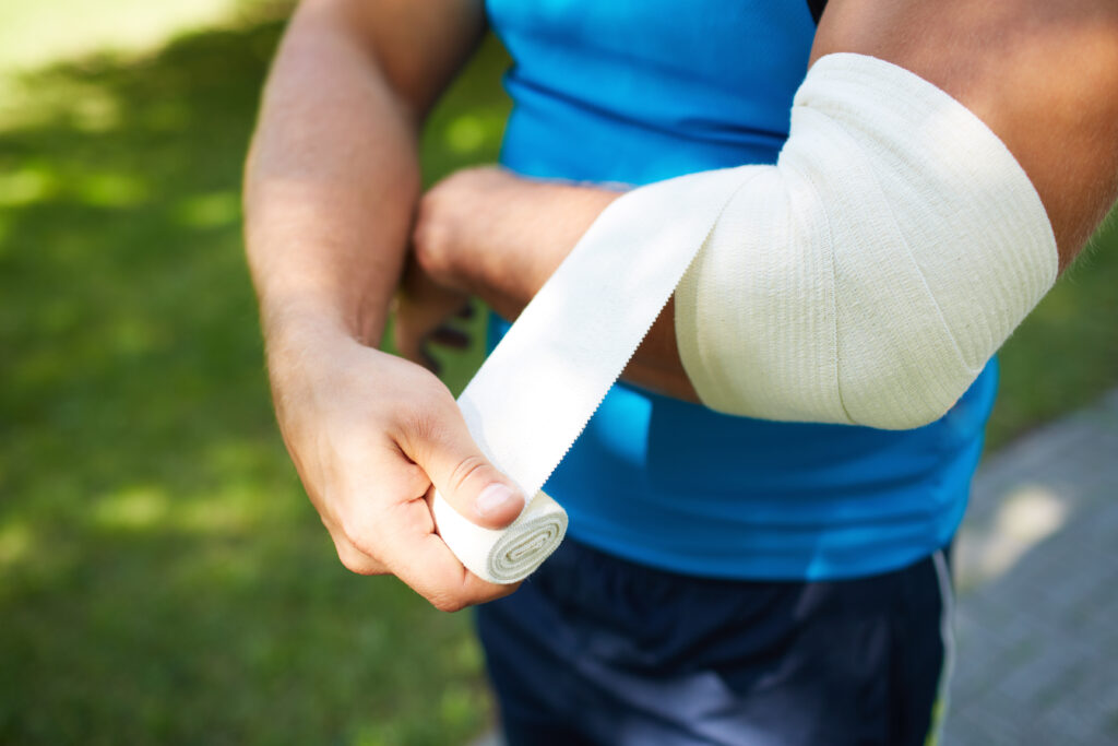 Man Bandaging Elbow